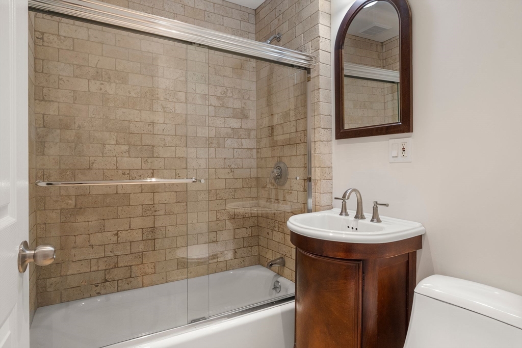 178 Hyde Park Avenue, Unit 3 Boston, MA 02130 - Photo 15 of 23 a bathroom with a sink a toilet and shower