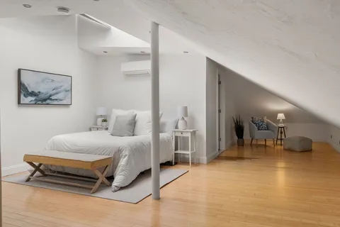 a spacious bedroom with a bed and a table in it