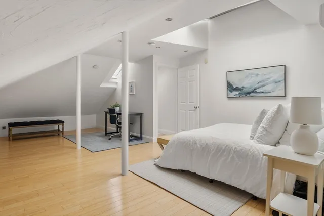 a bedroom with a bed and a chair