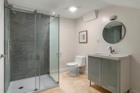 a bathroom with a toilet sink and shower