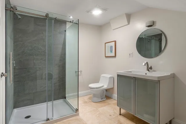 a bathroom with a toilet sink and shower