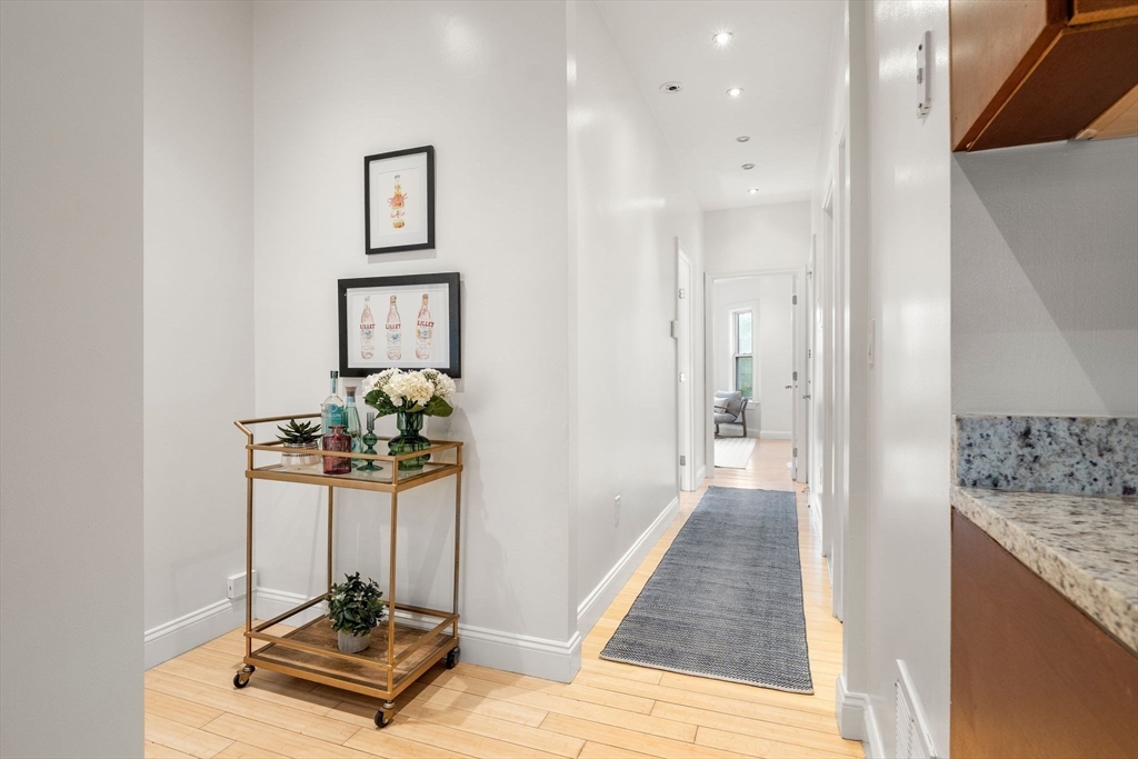 178 Hyde Park Avenue, Unit 3 Boston, MA 02130 - Photo 9 of 23 a view of a hallway with a livingroom and furniture
