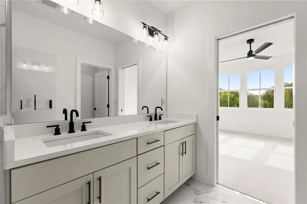 a bathroom with a double vanity sink and mirror