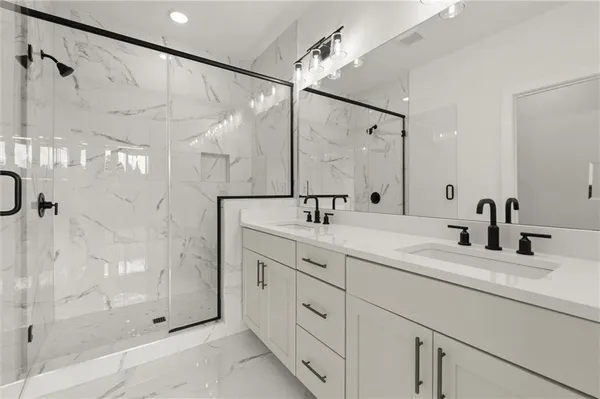 a bathroom with a shower sink and mirror