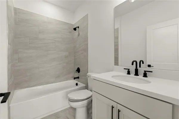 a bathroom with a sink a toilet and a bathtub