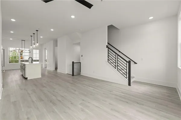 a view of a kitchen with furniture and wooden floor