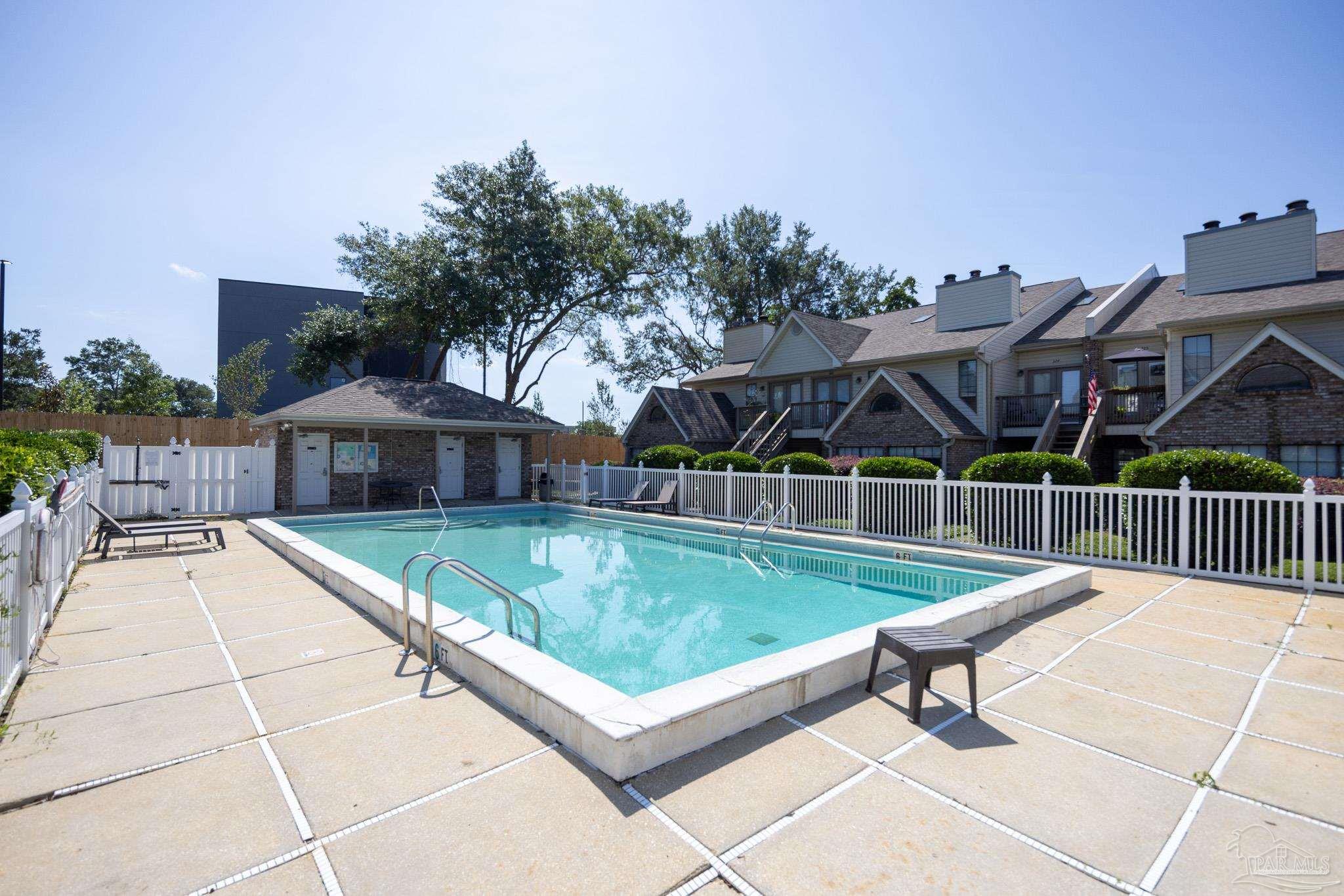 7150 Plantation Road, Unit 312 Pensacola, FL 32504 - Photo 13 of 14 a view of a patio with a table and chairs