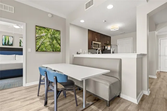 a large bed sitting in a bedroom next to a window