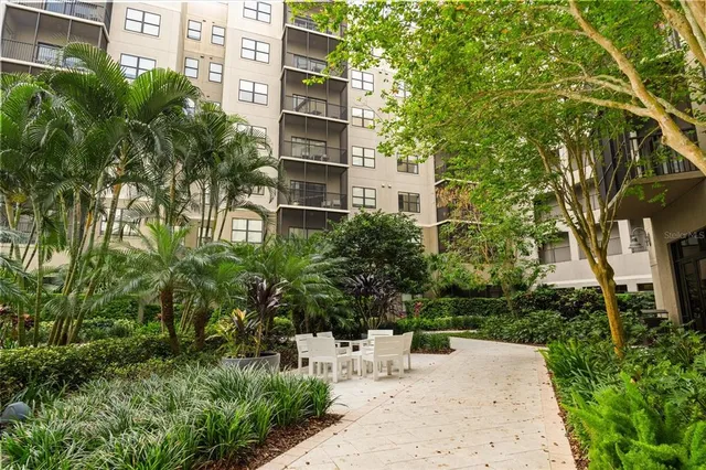 a backyard with table and chairs potted plants