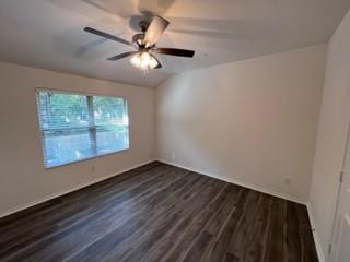 807 South 6th Street, Unit 3 Bonham, TX 75418 - Photo 2 of 8 Unfurnished room with dark wood-type flooring and vaulted ceiling