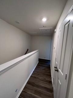 807 South 6th Street, Unit 3 Bonham, TX 75418 - Photo 3 of 8 Hallway featuring dark wood-style flooring, attic access, and an upstairs landing