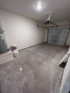 807 South 6th Street, Unit 3 Bonham, TX 75418 - Photo 6 of 8 Garage with water heater and a garage door opener