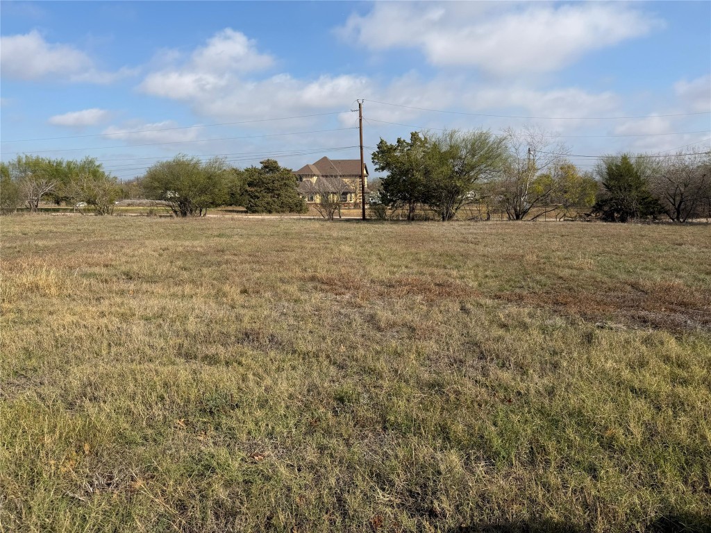 11622 A Doyle Overton Road Austin, TX 78719 - Photo 2 of 10 View of green lawn with a view of countryside