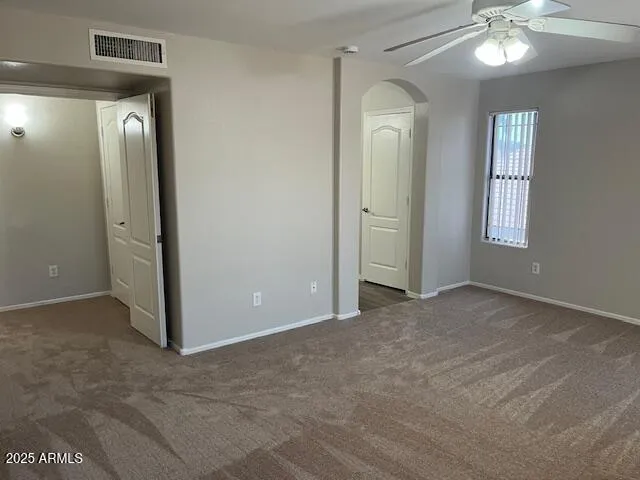 a bedroom with a large bed and a flat screen tv