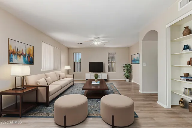 a living room with furniture and a wooden floor