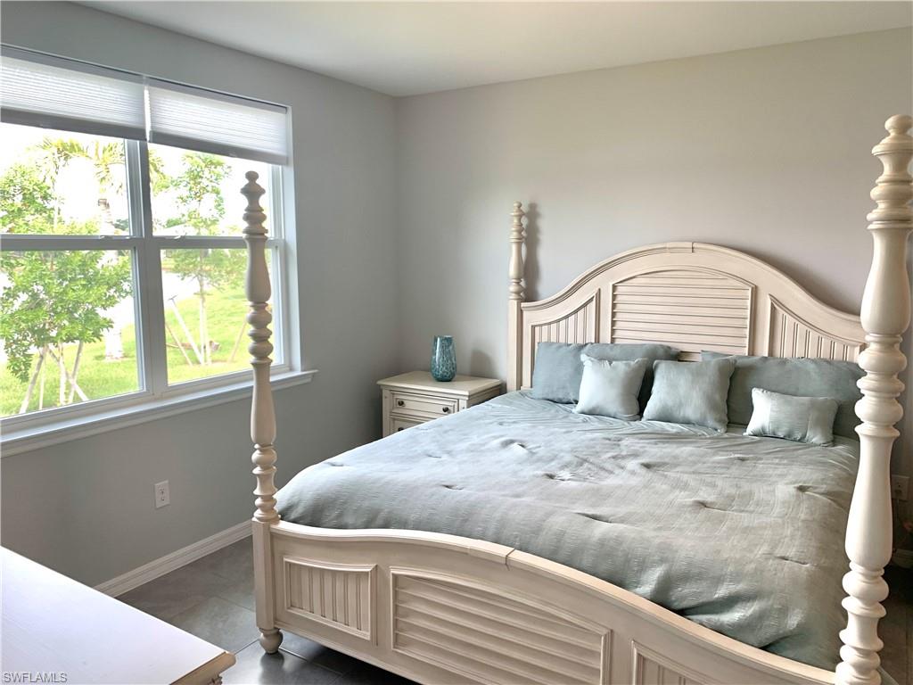 14632 Edgewater Circle Naples, FL 34114 - Photo 15 of 35 a bedroom with a bed and a window