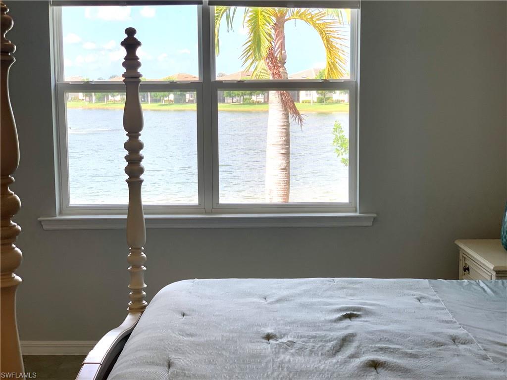 14632 Edgewater Circle Naples, FL 34114 - Photo 16 of 35 a bedroom with a bed and a window