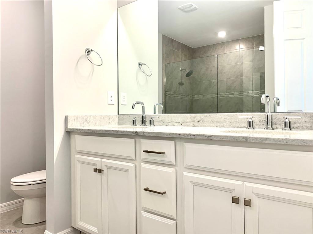 14632 Edgewater Circle Naples, FL 34114 - Photo 17 of 35 a bathroom with a sink and a toilet