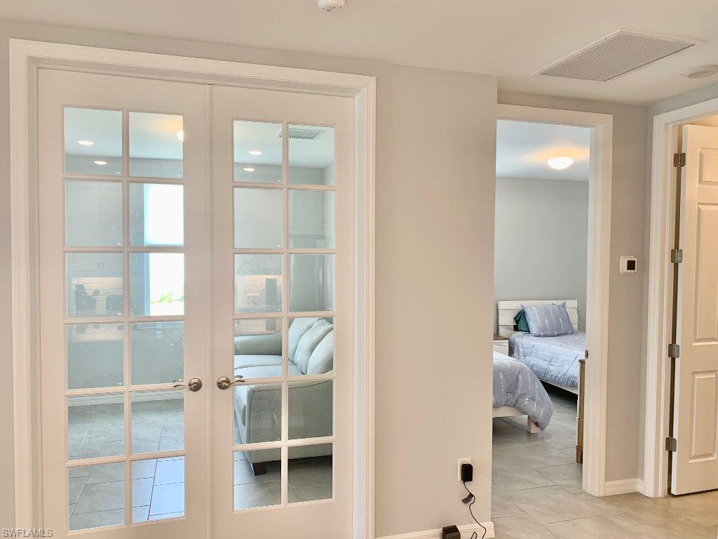 14632 Edgewater Circle Naples, FL 34114 - Photo 21 of 35 a view of a bedroom with wooden floor and bedroom