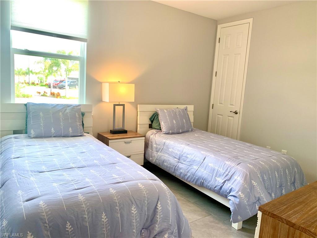 14632 Edgewater Circle Naples, FL 34114 - Photo 22 of 35 a bedroom with bed and window