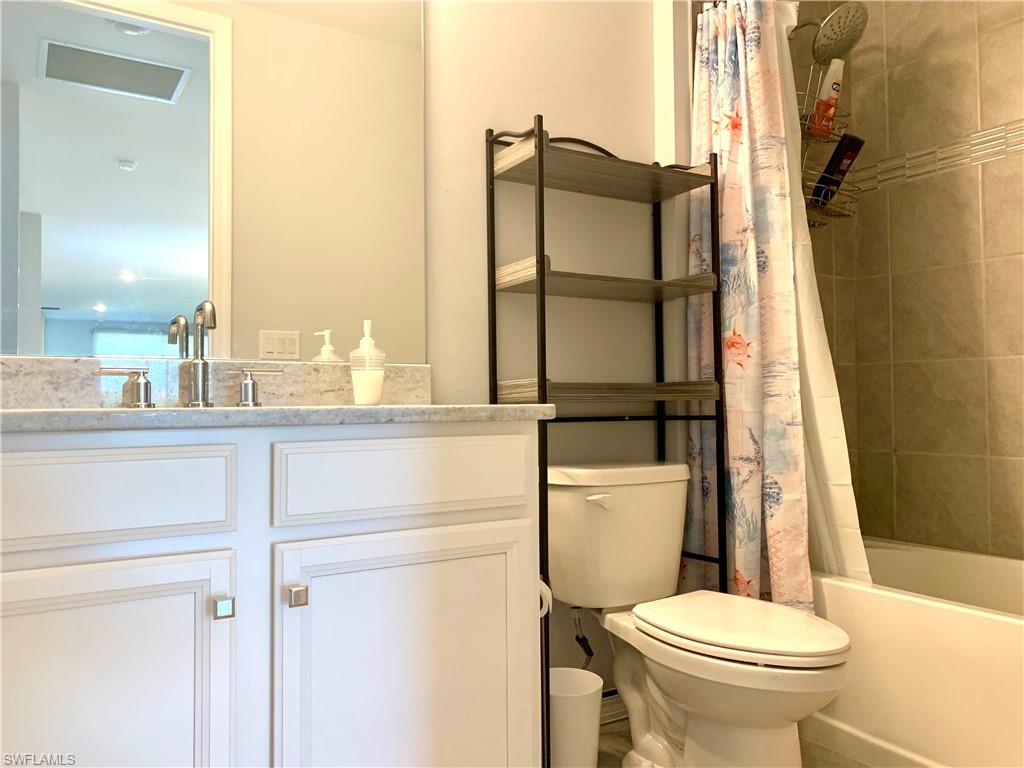 14632 Edgewater Circle Naples, FL 34114 - Photo 24 of 35 a bathroom with a toilet and a sink