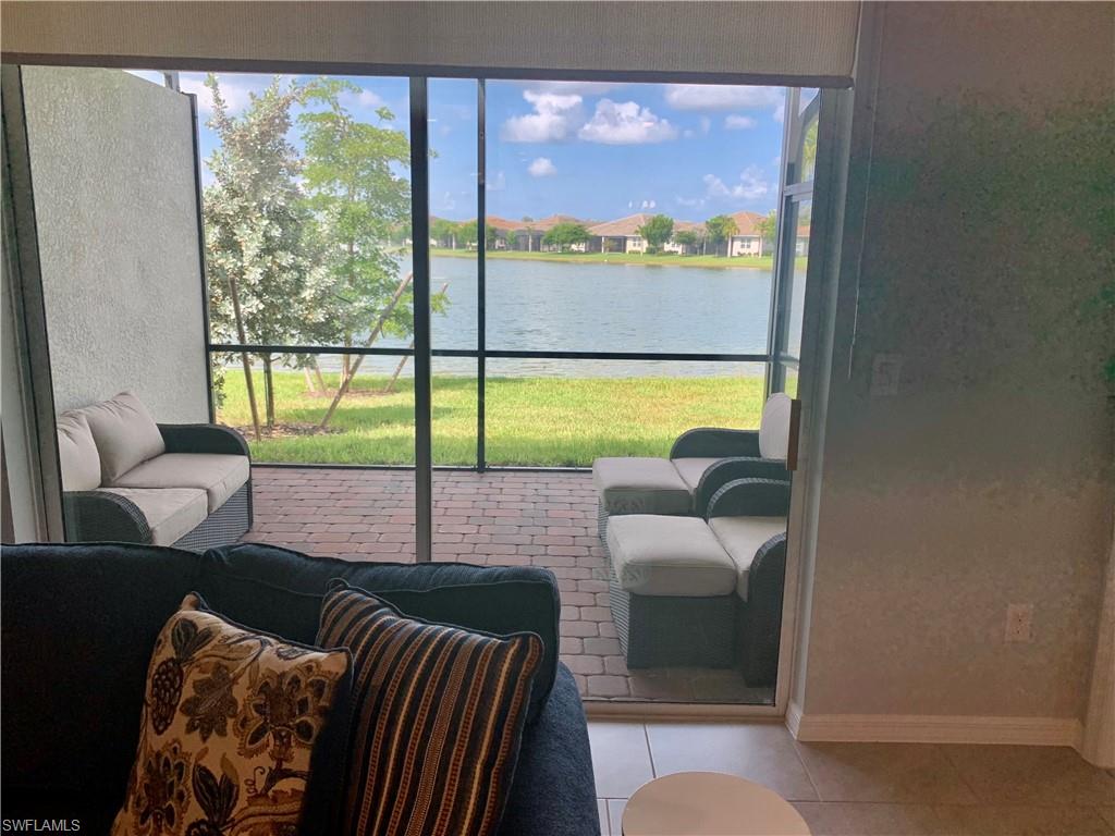 14632 Edgewater Circle Naples, FL 34114 - Photo 27 of 35 a bedroom with furniture and a large window