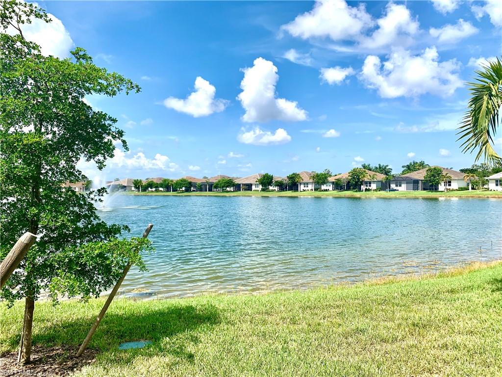 14632 Edgewater Circle Naples, FL 34114 - Photo 28 of 35 a view of a lake with houses in the background