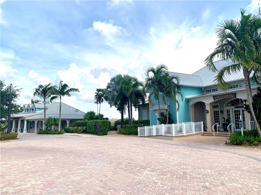 14632 Edgewater Circle Naples, FL 34114 - Photo 29 of 35 a view of a house with a yard and palm trees