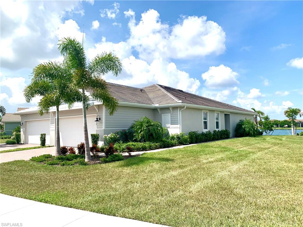 14632 Edgewater Circle Naples, FL 34114 - Photo 3 of 35 a front view of house with yard and green space