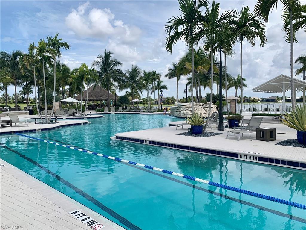 14632 Edgewater Circle Naples, FL 34114 - Photo 33 of 35 a view of a swimming pool with a table and chairs