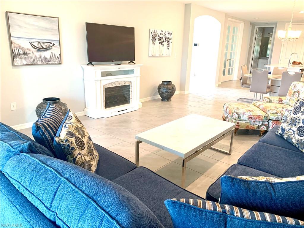 14632 Edgewater Circle Naples, FL 34114 - Photo 8 of 35 a living room with furniture and a flat screen tv