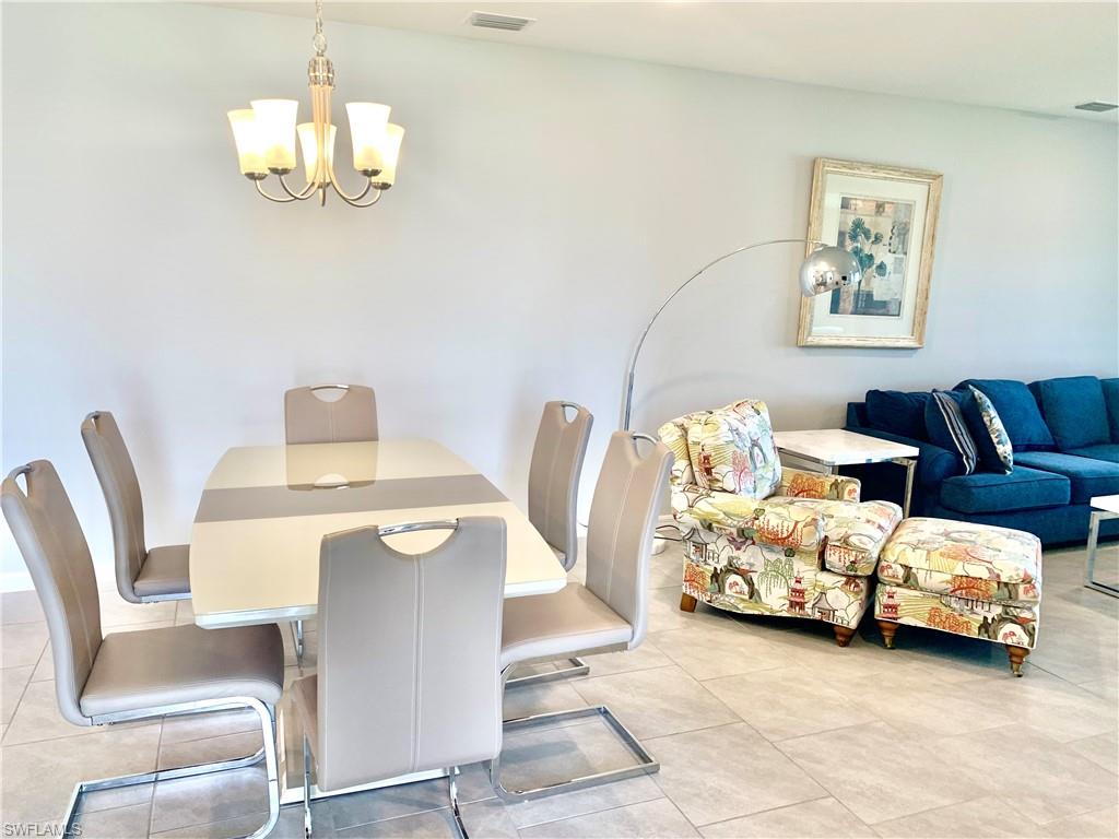 14632 Edgewater Circle Naples, FL 34114 - Photo 9 of 35 a bedroom with furniture and a chandelier