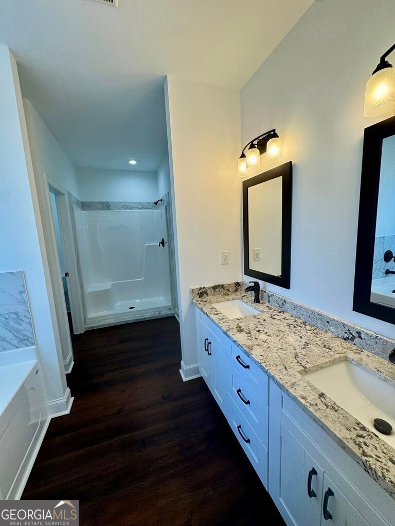 230 Woodland Heights Road Dublin, GA 31021 - Photo 11 of 30 a bathroom with a granite countertop double vanity sink and a mirror