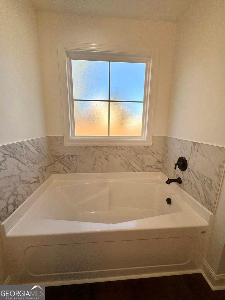 230 Woodland Heights Road Dublin, GA 31021 - Photo 13 of 30 a bathroom with a bathtub and window