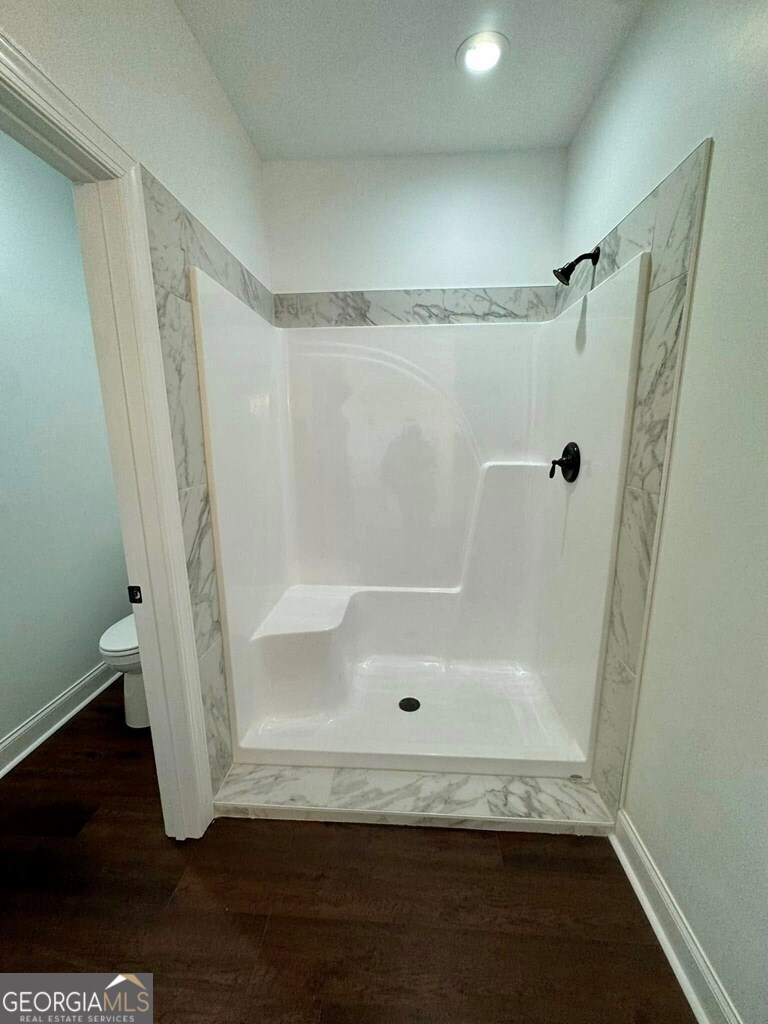 230 Woodland Heights Road Dublin, GA 31021 - Photo 14 of 30 a bathroom with a glass shower door