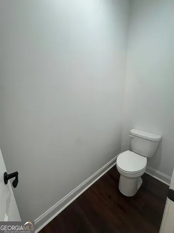 a white toilet sitting in a bathroom