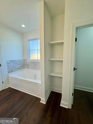 a bathroom with a bathtub and a vanity