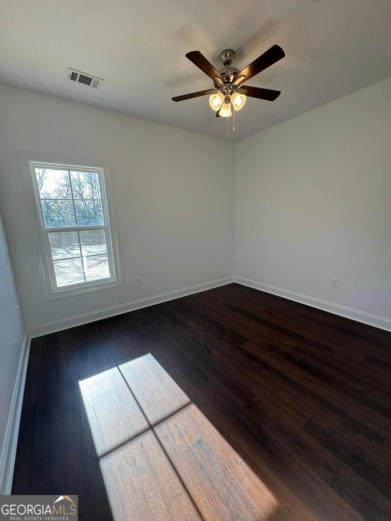 230 Woodland Heights Road Dublin, GA 31021 - Photo 21 of 30 wooden floor in an empty room with a window