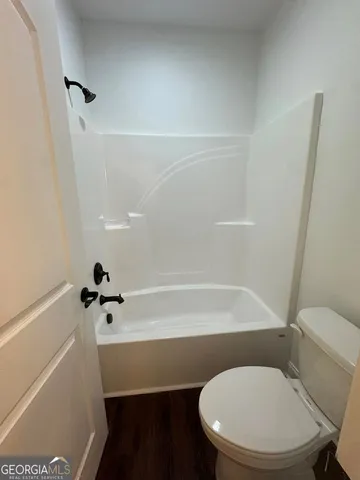 a bathroom with a toilet and a bathtub