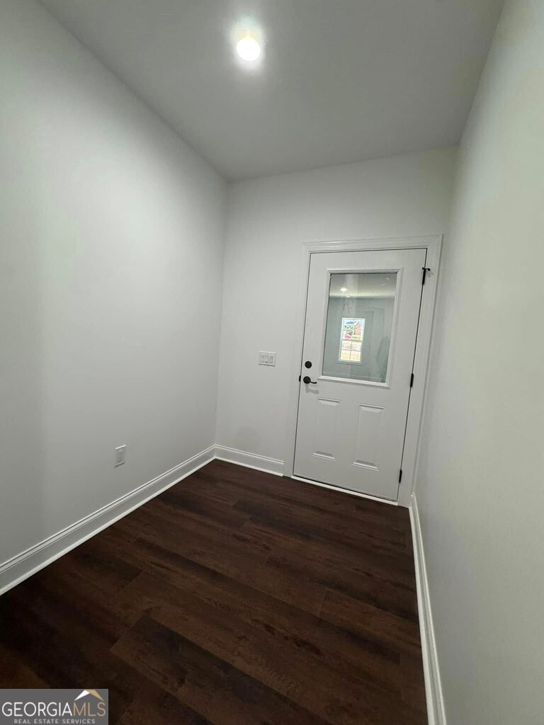230 Woodland Heights Road Dublin, GA 31021 - Photo 25 of 30 an empty room with wooden floor and mirror