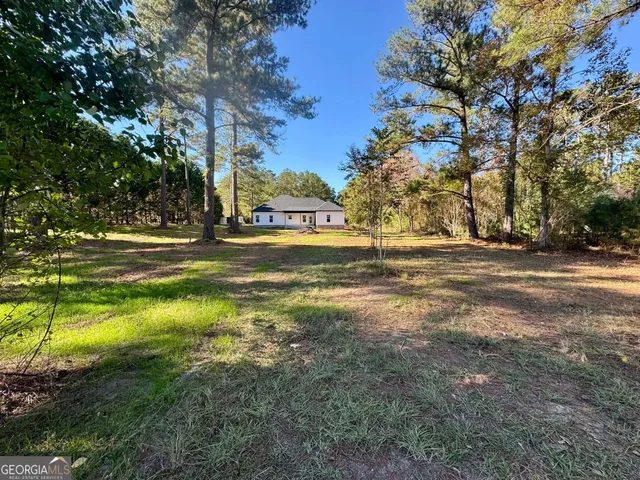 a view of the trees in front of a house
