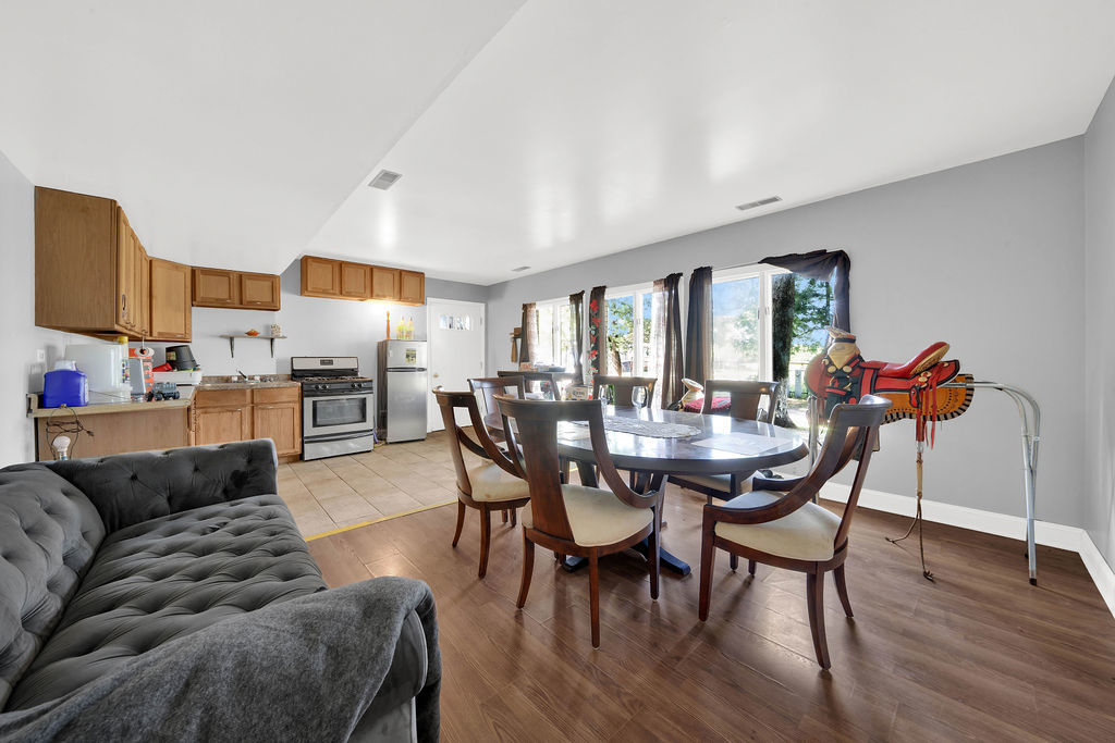 7245 West Dralle Road Monee, IL 60449 - Photo 11 of 73 a view of a dining room with furniture and wooden floor