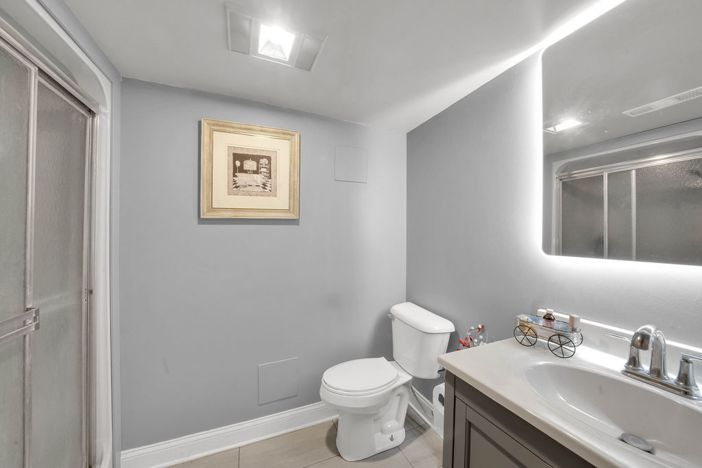 7245 West Dralle Road Monee, IL 60449 - Photo 17 of 73 a bathroom with a toilet sink vanity and mirror