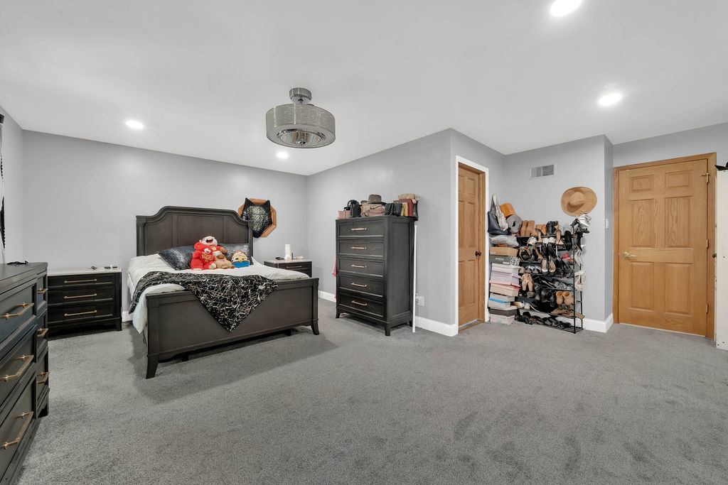 7245 West Dralle Road Monee, IL 60449 - Photo 25 of 73 a spacious bedroom with a bed and a walk in closet