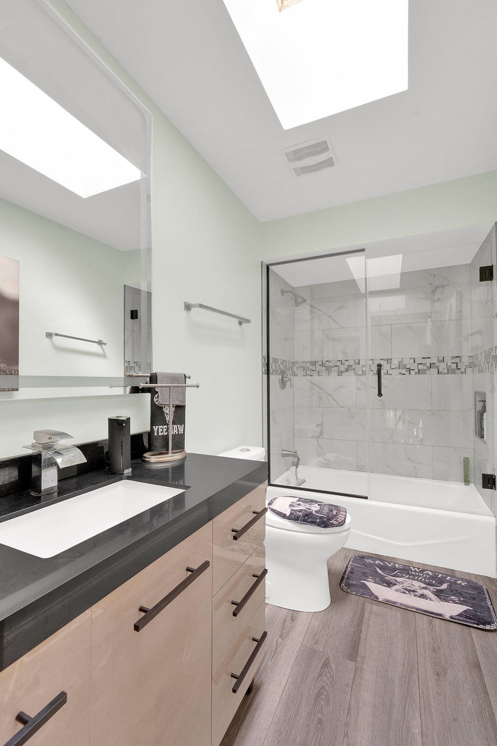 7245 West Dralle Road Monee, IL 60449 - Photo 31 of 73 a bathroom with a granite countertop sink a toilet a mirror and bathtub