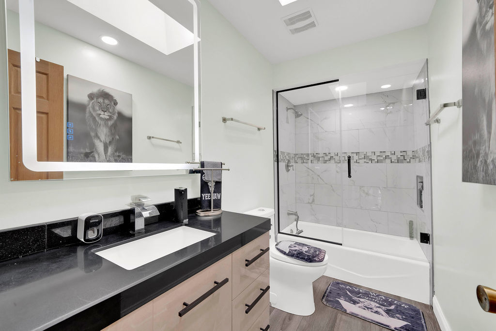 7245 West Dralle Road Monee, IL 60449 - Photo 32 of 73 a bathroom with a granite countertop sink a toilet a mirror and shower