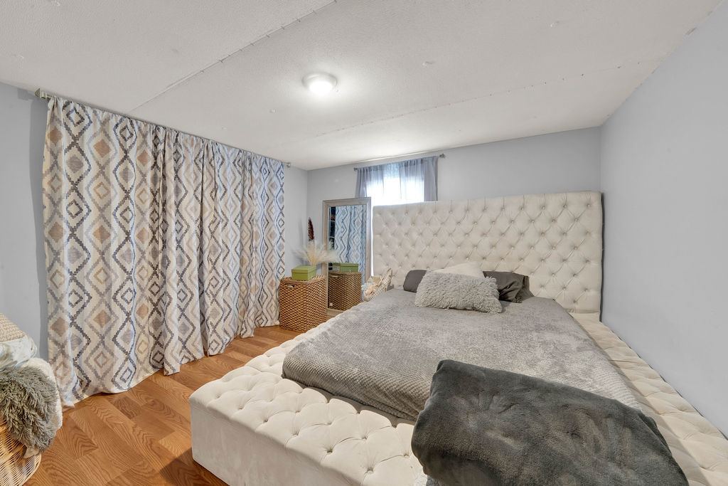 7245 West Dralle Road Monee, IL 60449 - Photo 34 of 73 a bedroom with a large bed and a wooden floor