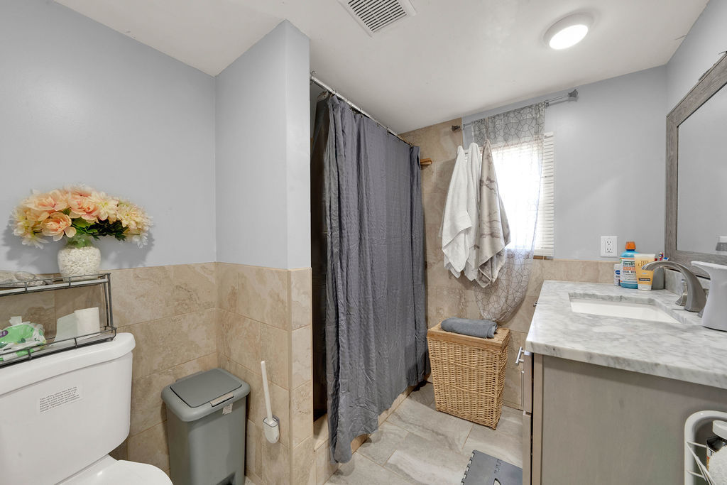 7245 West Dralle Road Monee, IL 60449 - Photo 37 of 73 a bathroom with a granite countertop sink a mirror and a toilet