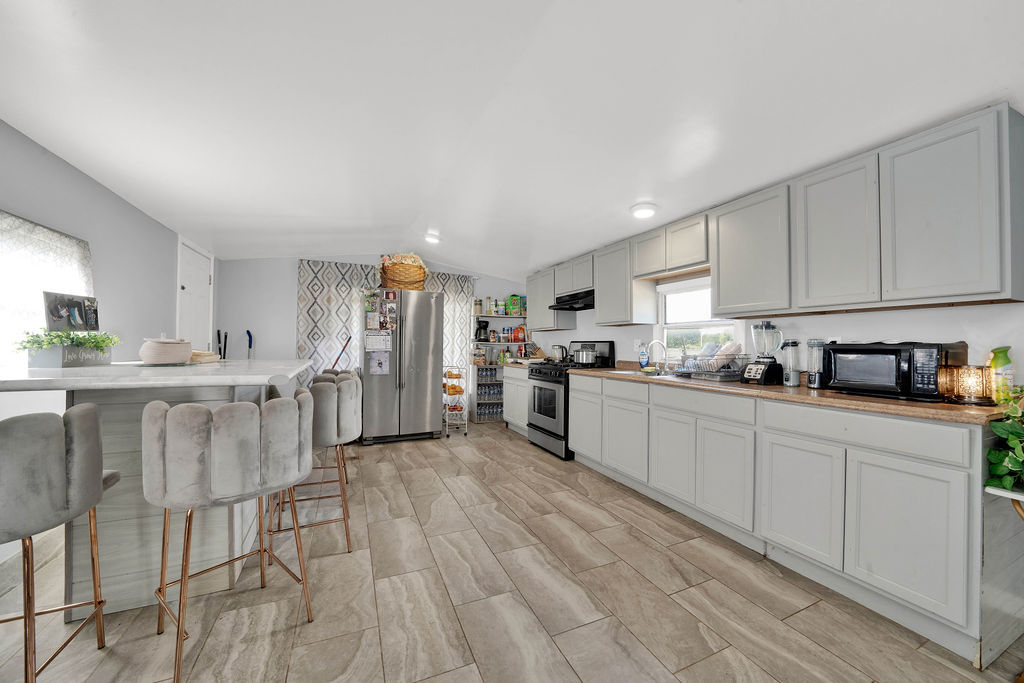 7245 West Dralle Road Monee, IL 60449 - Photo 40 of 73 a kitchen with white cabinets and stainless steel appliances