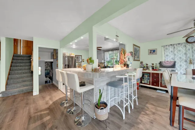a view of a dining room with furniture and wooden floor
